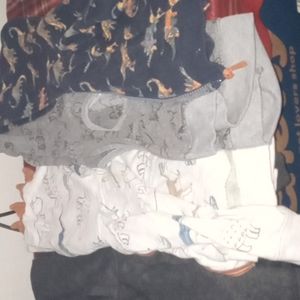 There are four sweater like pullovers vest with no sleeves for little boys 2T